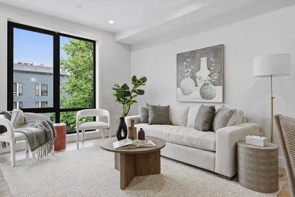 a living room with furniture and a large window