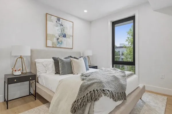 a bedroom with bed and a window