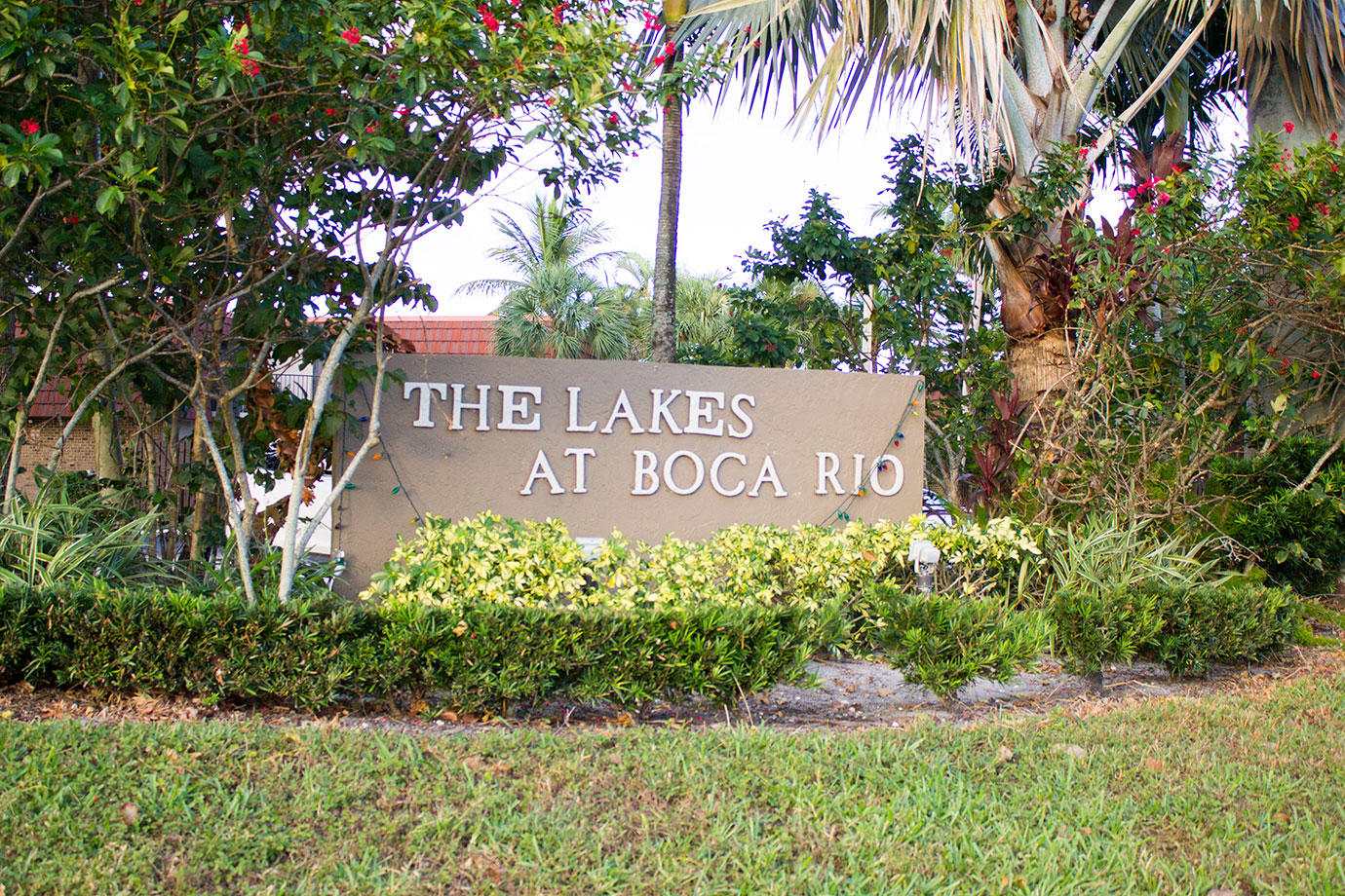 8265 Boca Rio Drive Boca Raton, FL 33433 - Photo 18 of 18 a sign that is sitting in front of flowers