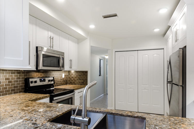 363 West Camino Real, Unit 4 Boca Raton, FL 33432 - Photo 9 of 37 a kitchen with stainless steel appliances a refrigerator and a stove top oven