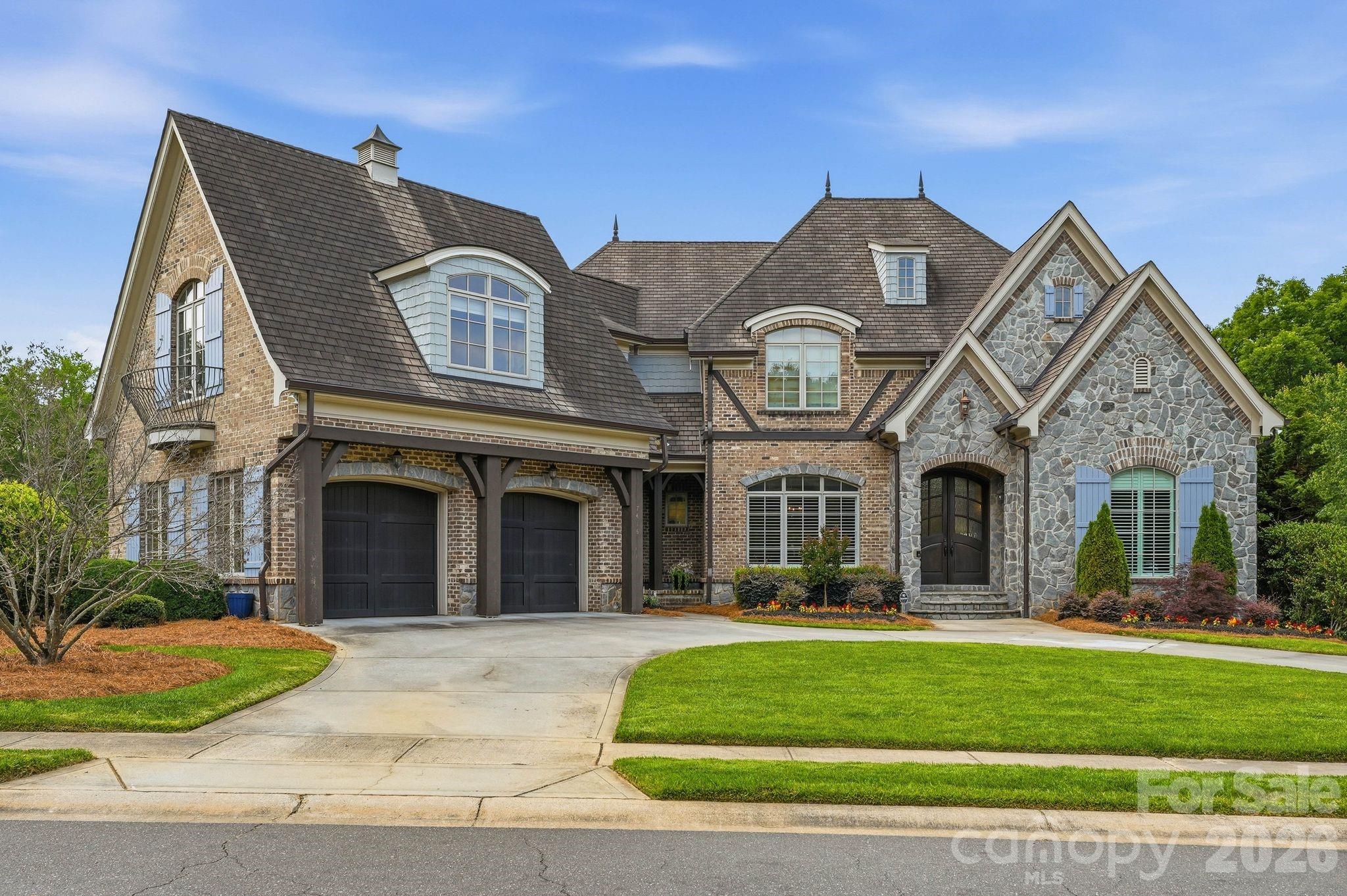 7416 Lee Rea Road Charlotte, NC 28226 - Photo 1 of 48 a front view of a house with a garden and plants