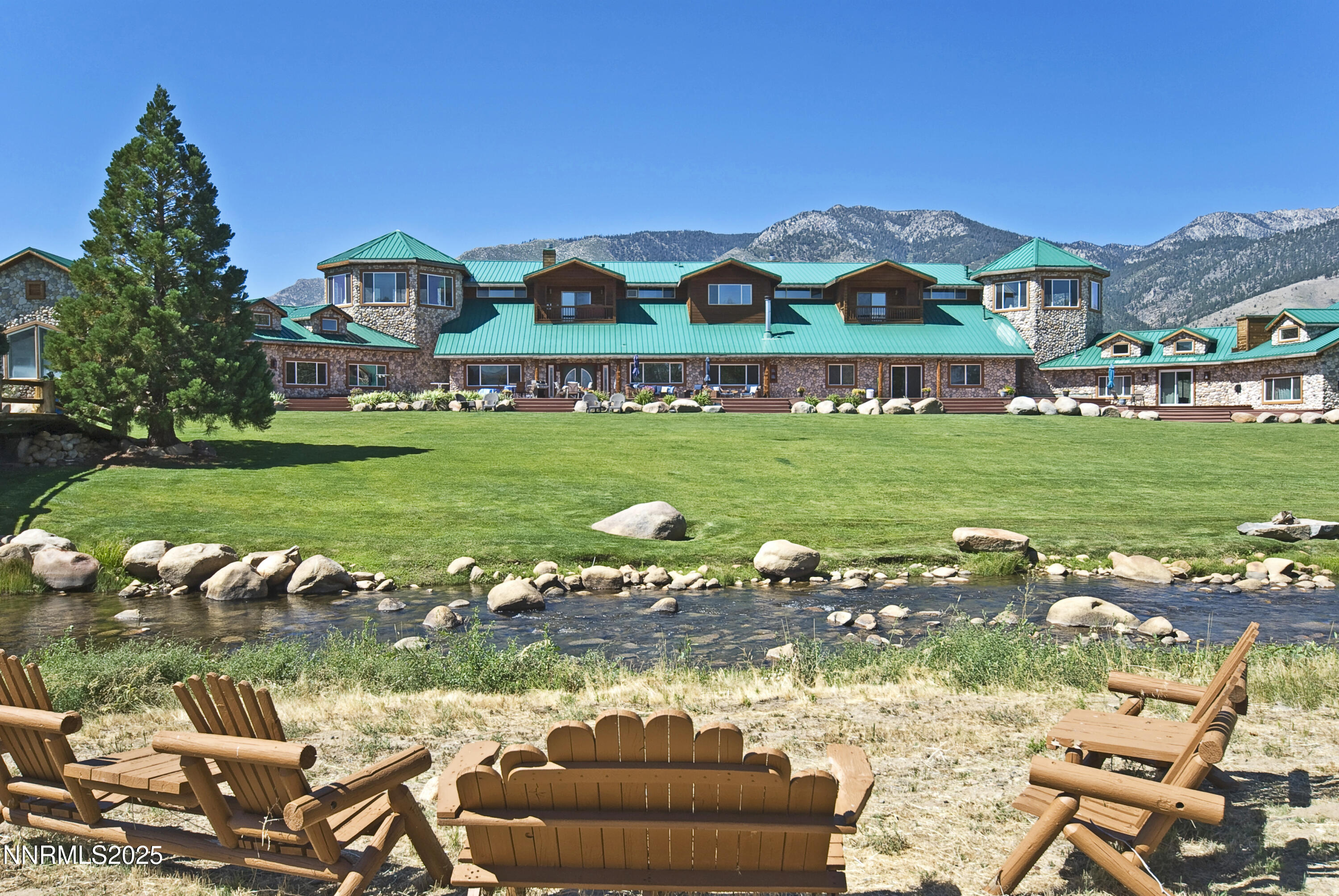 827 River Ranch Road Markleeville, CA 96120 - Photo 11 of 46 a view of a lake with lawn chairs and large trees