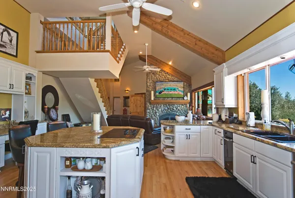 a kitchen with a stove a refrigerator and a view of living room