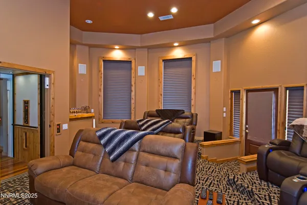 a living room with furniture ceiling fan