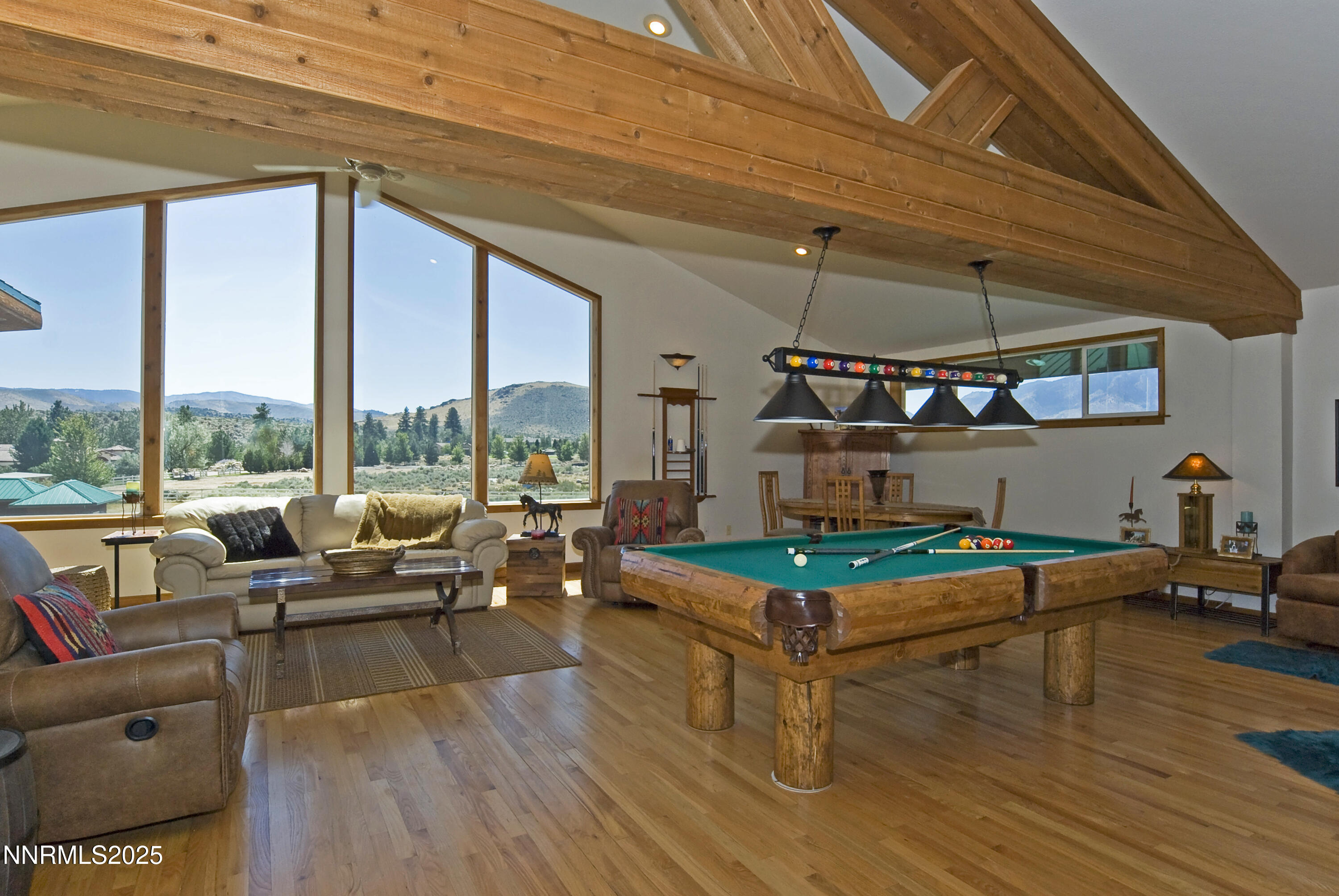 827 River Ranch Road Markleeville, CA 96120 - Photo 31 of 46 a living room with furniture a rug and a floor to ceiling window