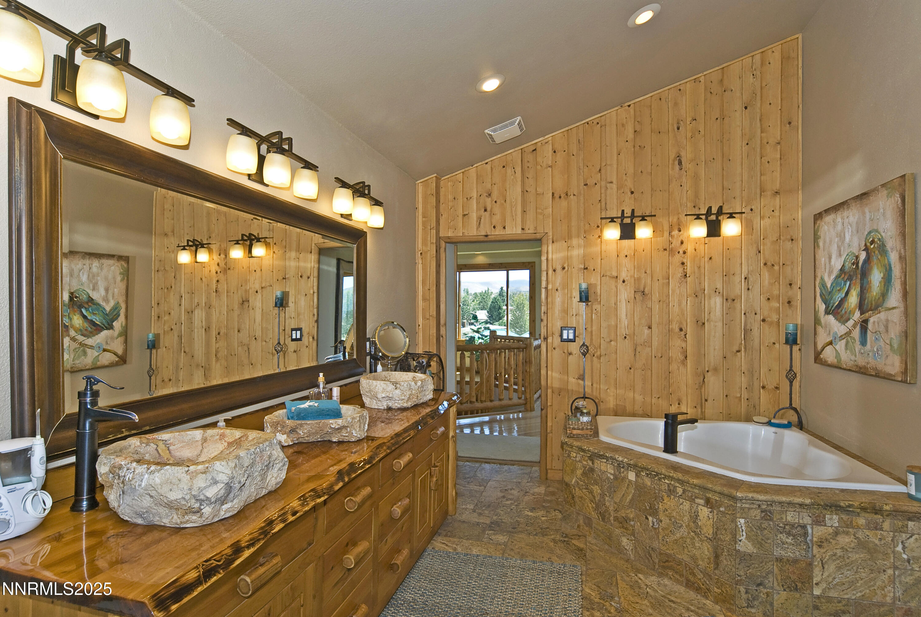827 River Ranch Road Markleeville, CA 96120 - Photo 32 of 46 a bathroom with a tub a double vanity sink and mirror