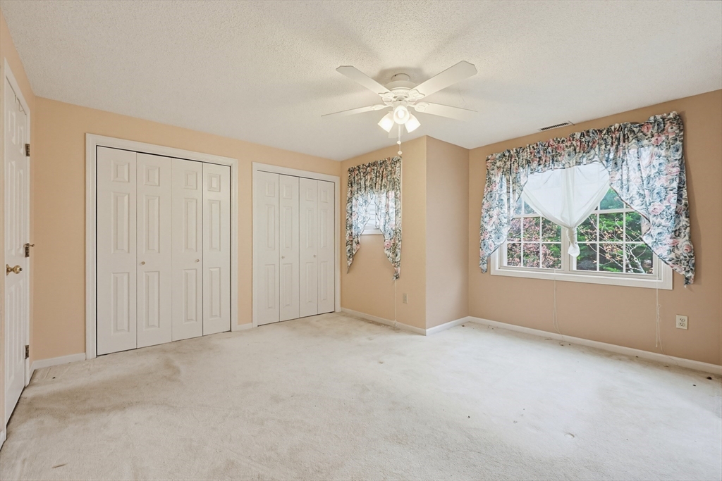 3301 Maple Brook Road, Unit 301 Bellingham, MA 02019 - Photo 19 of 29 an empty room with windows and fan