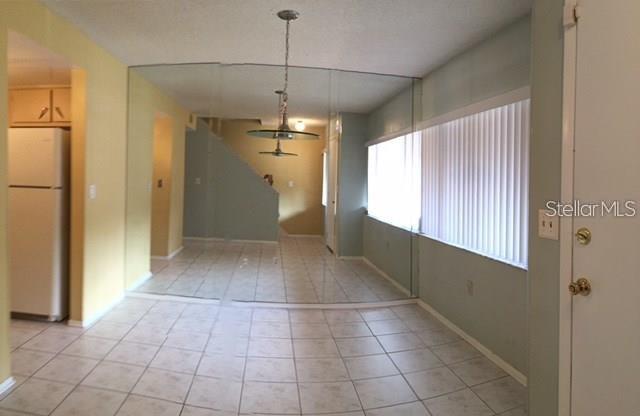 5812 Windhover Drive, Unit 5812 Orlando, FL 32819 - Photo 11 of 27 a view of a hallway with a chandelier fan and windows