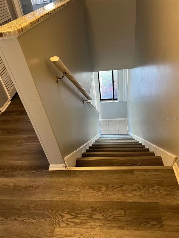 5812 Windhover Drive, Unit 5812 Orlando, FL 32819 - Photo 15 of 27 a view of entryway and hall with wooden floor