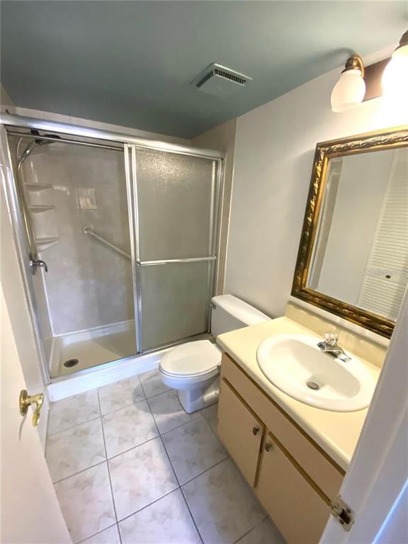 5812 Windhover Drive, Unit 5812 Orlando, FL 32819 - Photo 20 of 27 a bathroom with a sink toilet and shower