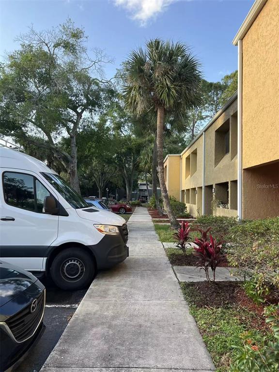 5812 Windhover Drive, Unit 5812 Orlando, FL 32819 - Photo 24 of 27 a view of street with parked cars