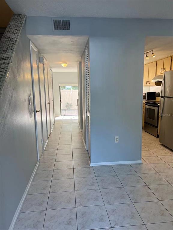 5812 Windhover Drive, Unit 5812 Orlando, FL 32819 - Photo 4 of 27 a view of a hallway with wooden floor