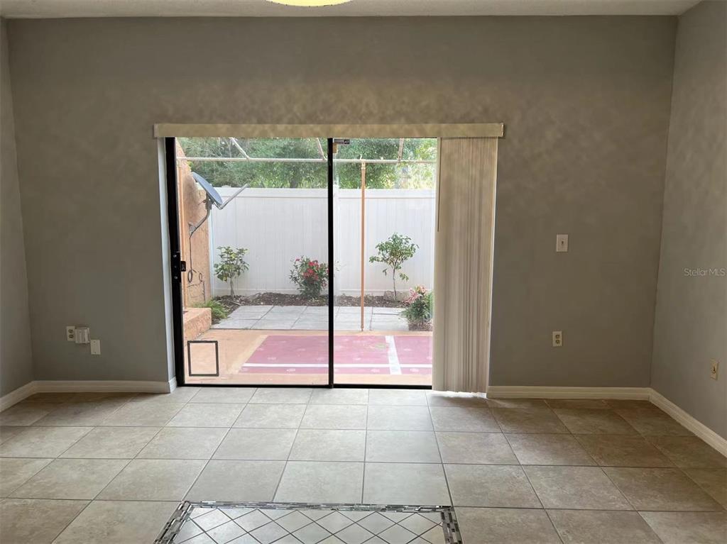 5812 Windhover Drive, Unit 5812 Orlando, FL 32819 - Photo 6 of 27 a empty room with glass door