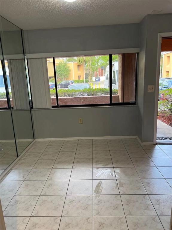 5812 Windhover Drive, Unit 5812 Orlando, FL 32819 - Photo 9 of 27 a view of an empty room with a window