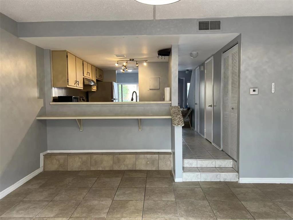 5812 Windhover Drive, Unit 5812 Orlando, FL 32819 - Photo 10 of 27 a view of a hallway with entryway and chandelier