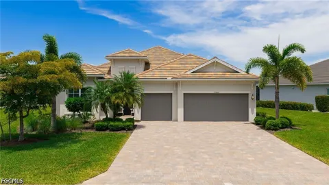 a front view of a house with a garden and a yard