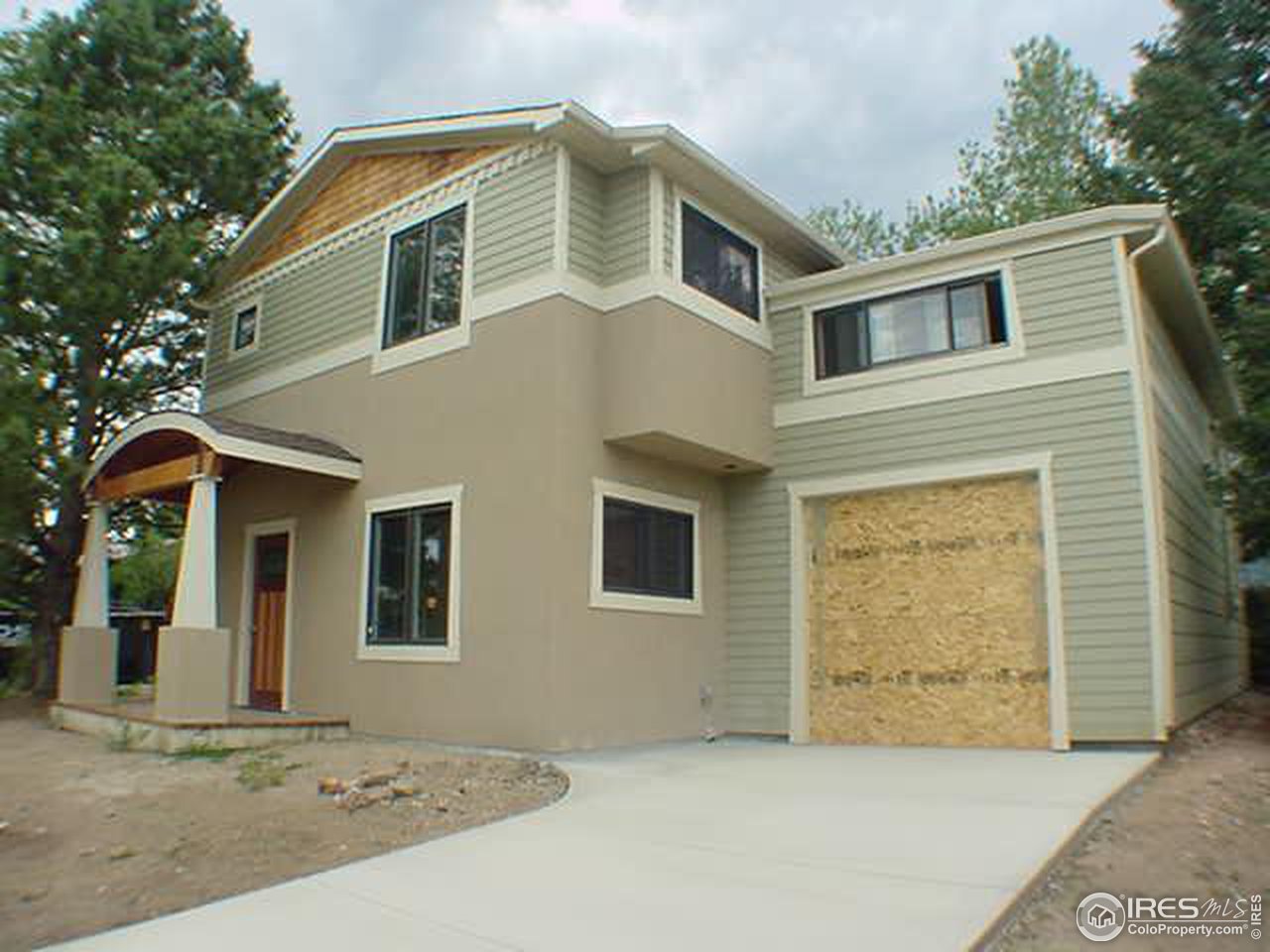 1395 Georgetown Road Boulder, CO 80305 - Photo 1 of 16 a front view of a house with a yard and garage