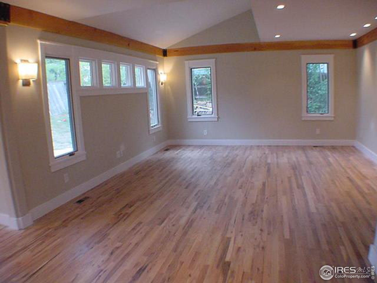 1395 Georgetown Road Boulder, CO 80305 - Photo 13 of 16 a view of an empty room with wooden floor and a window
