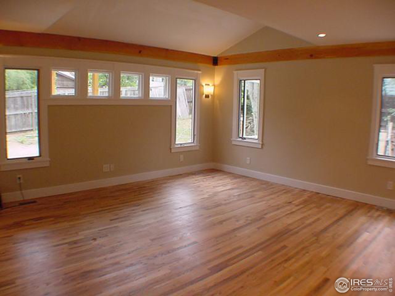 1395 Georgetown Road Boulder, CO 80305 - Photo 5 of 16 a view of an empty room with wooden floor and a window