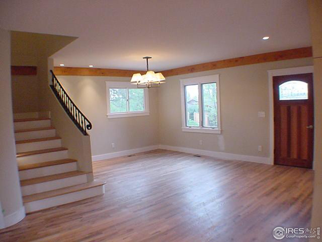 1395 Georgetown Road Boulder, CO 80305 - Photo 6 of 16 a view of an empty room with wooden floor and a window