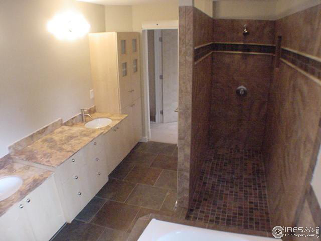 1395 Georgetown Road Boulder, CO 80305 - Photo 10 of 16 a bathroom with a granite countertop shower and a sink