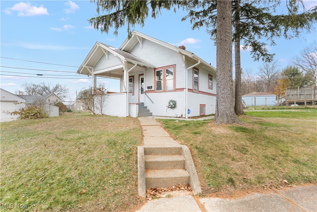 150 Diagonal Street Rittman, OH 44270 - Photo 2 of 21 View of front of home with covered porch and a front lawn