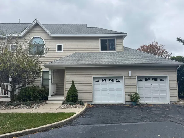 a front view of a house with garage