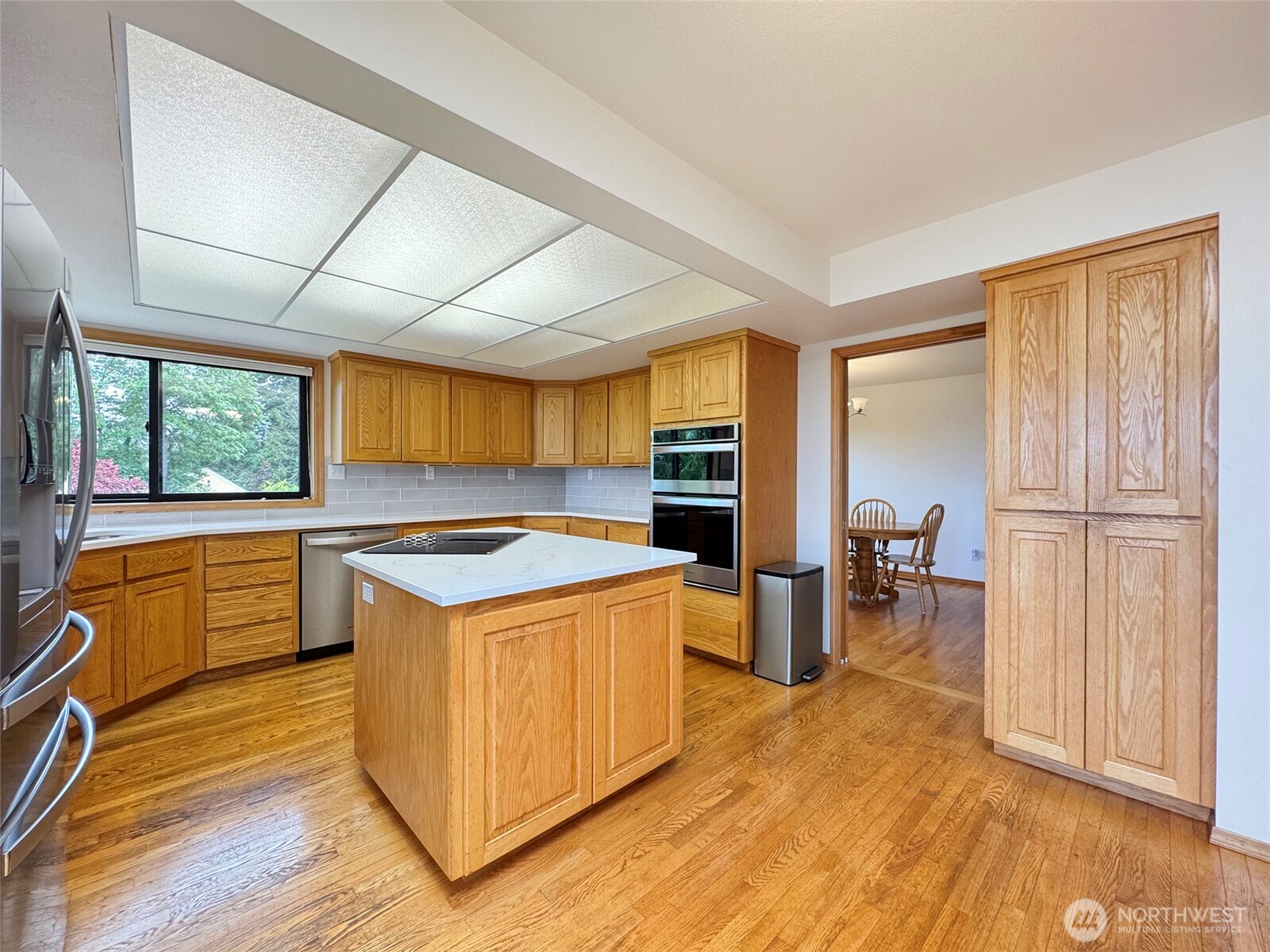 412 Doe Run Road Sequim, WA 98382 - Photo 12 of 40 a kitchen with a stove a sink and a refrigerator