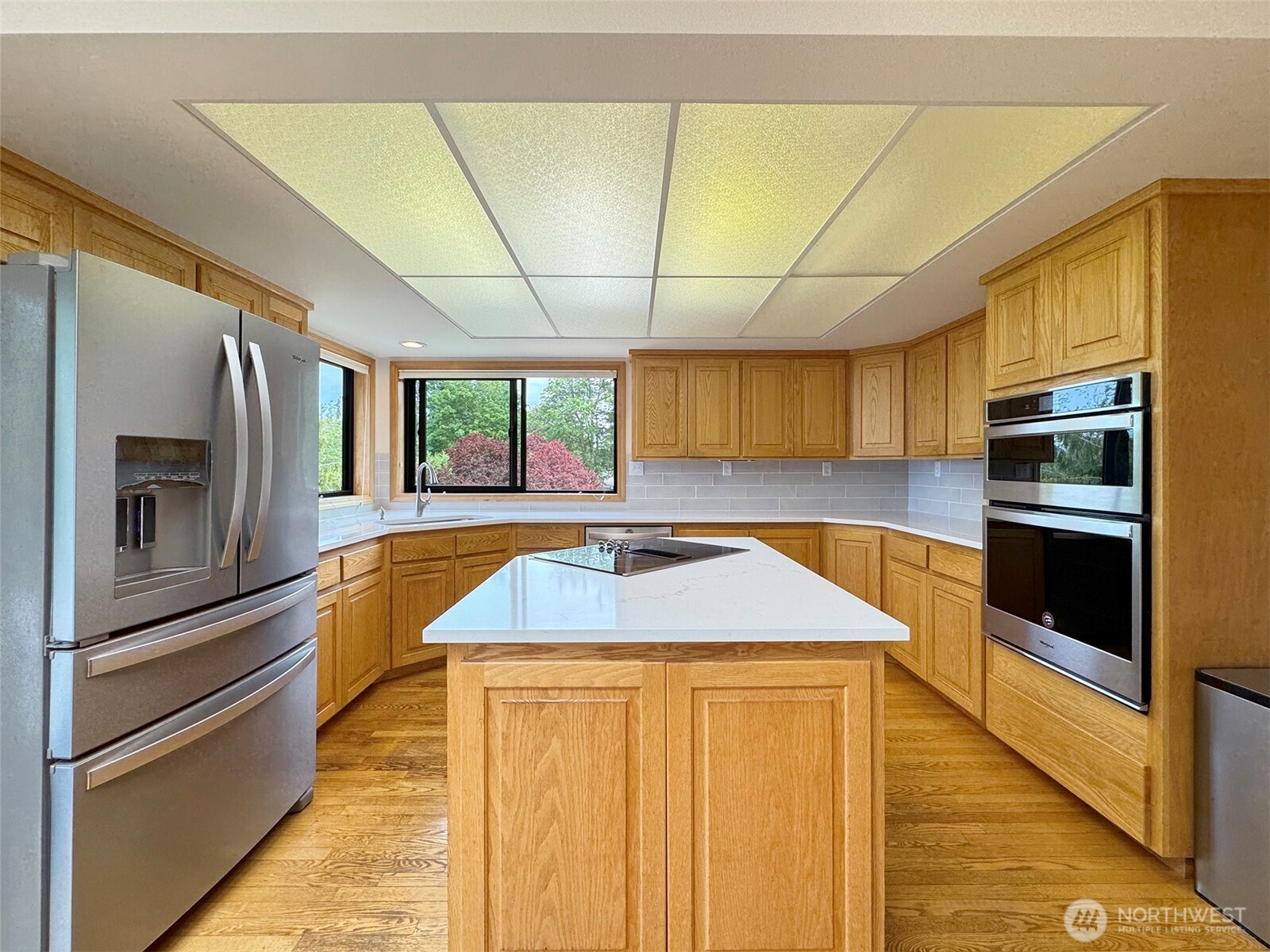 412 Doe Run Road Sequim, WA 98382 - Photo 13 of 40 a kitchen with stainless steel appliances kitchen island granite countertop a refrigerator stove and sink