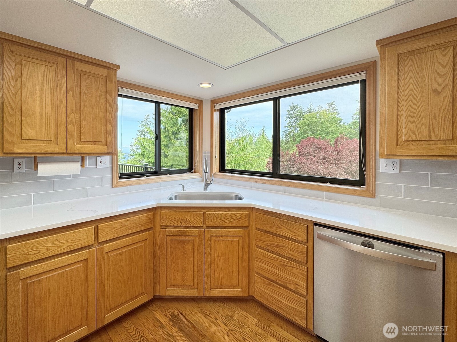 412 Doe Run Road Sequim, WA 98382 - Photo 14 of 40 a kitchen with a sink window and cabinets