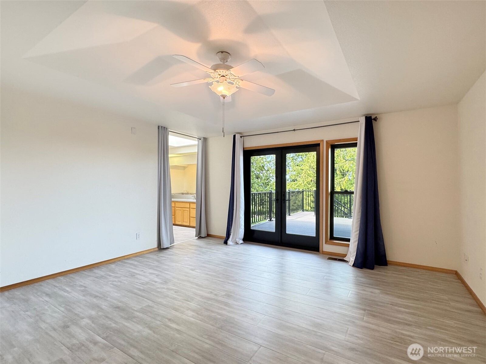 412 Doe Run Road Sequim, WA 98382 - Photo 20 of 40 a view of an empty room with wooden floor and a window