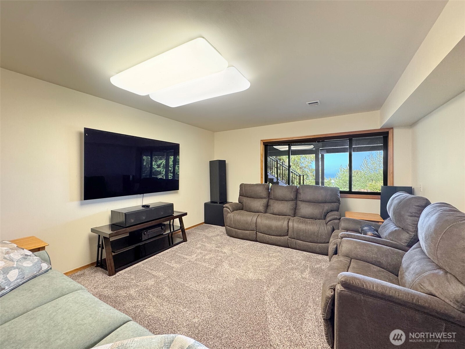 412 Doe Run Road Sequim, WA 98382 - Photo 35 of 40 a living room with furniture and a flat screen tv
