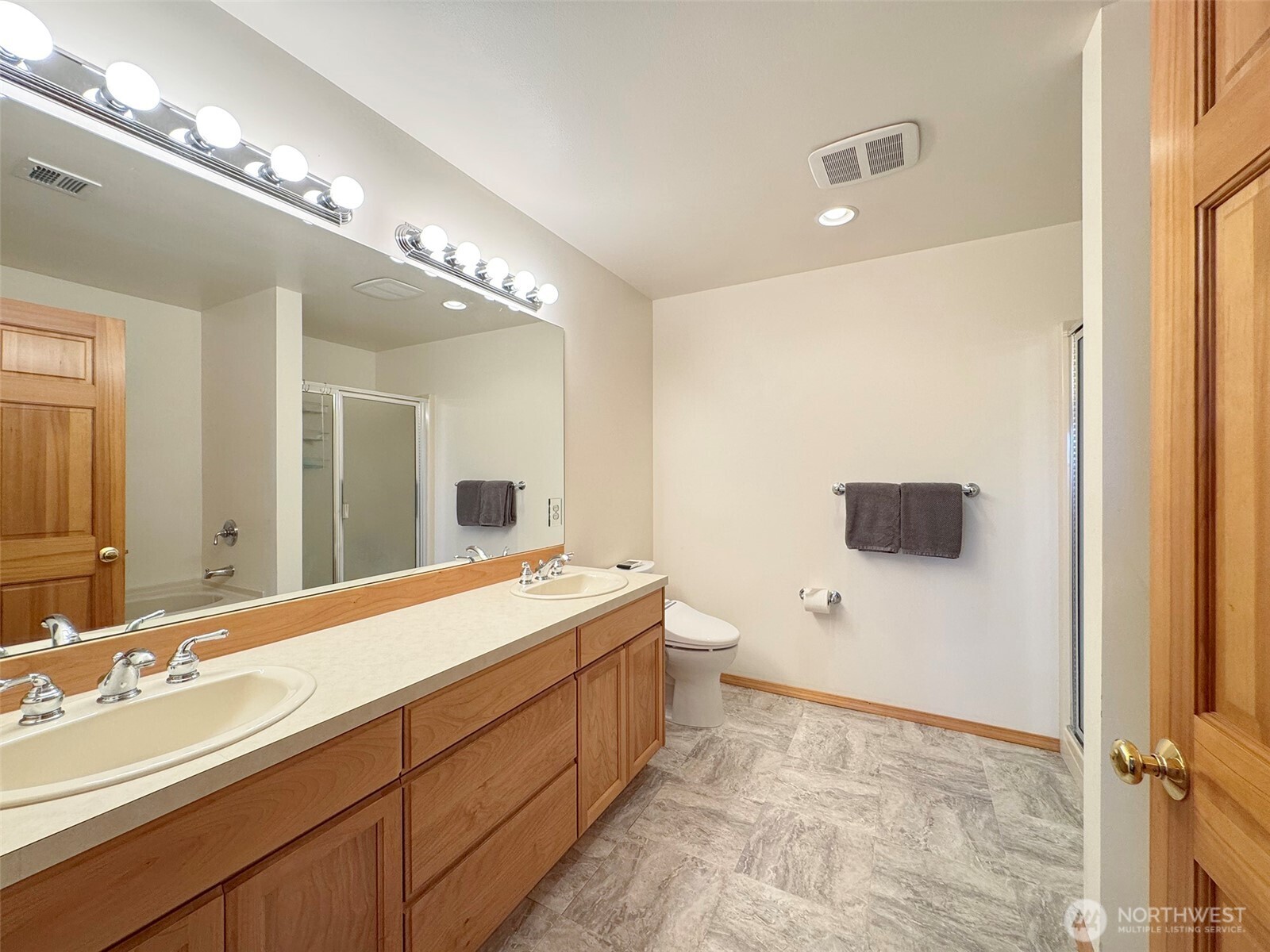 412 Doe Run Road Sequim, WA 98382 - Photo 37 of 40 a spacious bathroom with a double vanity sink and mirror