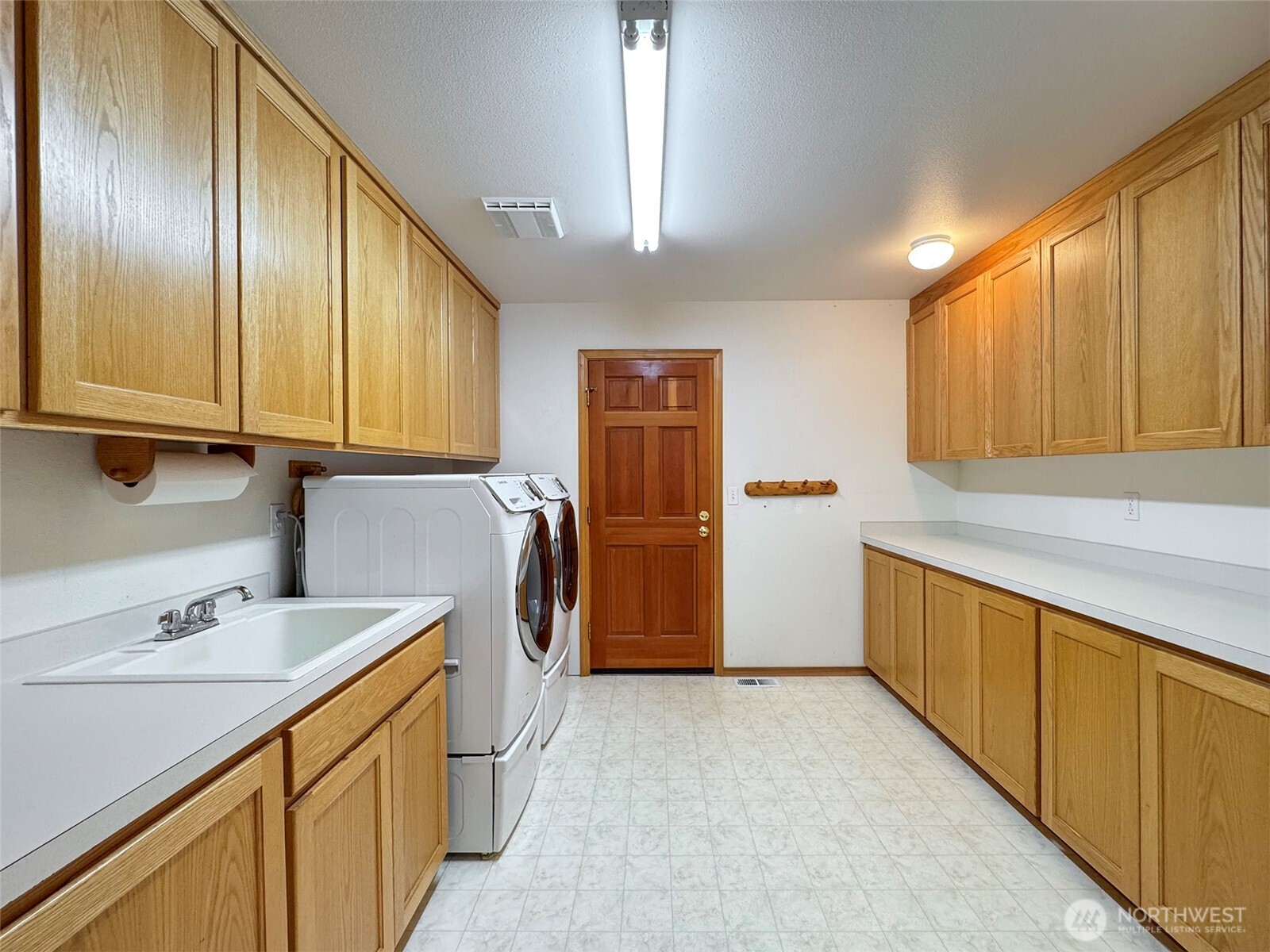 412 Doe Run Road Sequim, WA 98382 - Photo 38 of 40 a kitchen with granite countertop a sink a counter space cabinets and stainless steel appliances