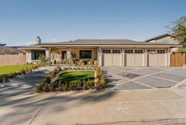 a front view of a house with a garden