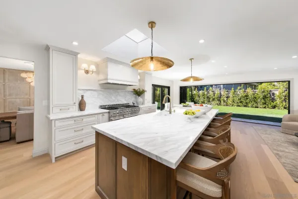 a kitchen with a stove cabinets and wooden floor