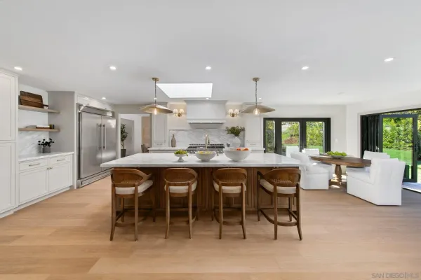 a living room with furniture and kitchen view