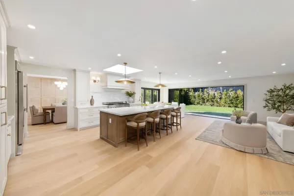 a bedroom with a bed and large windows