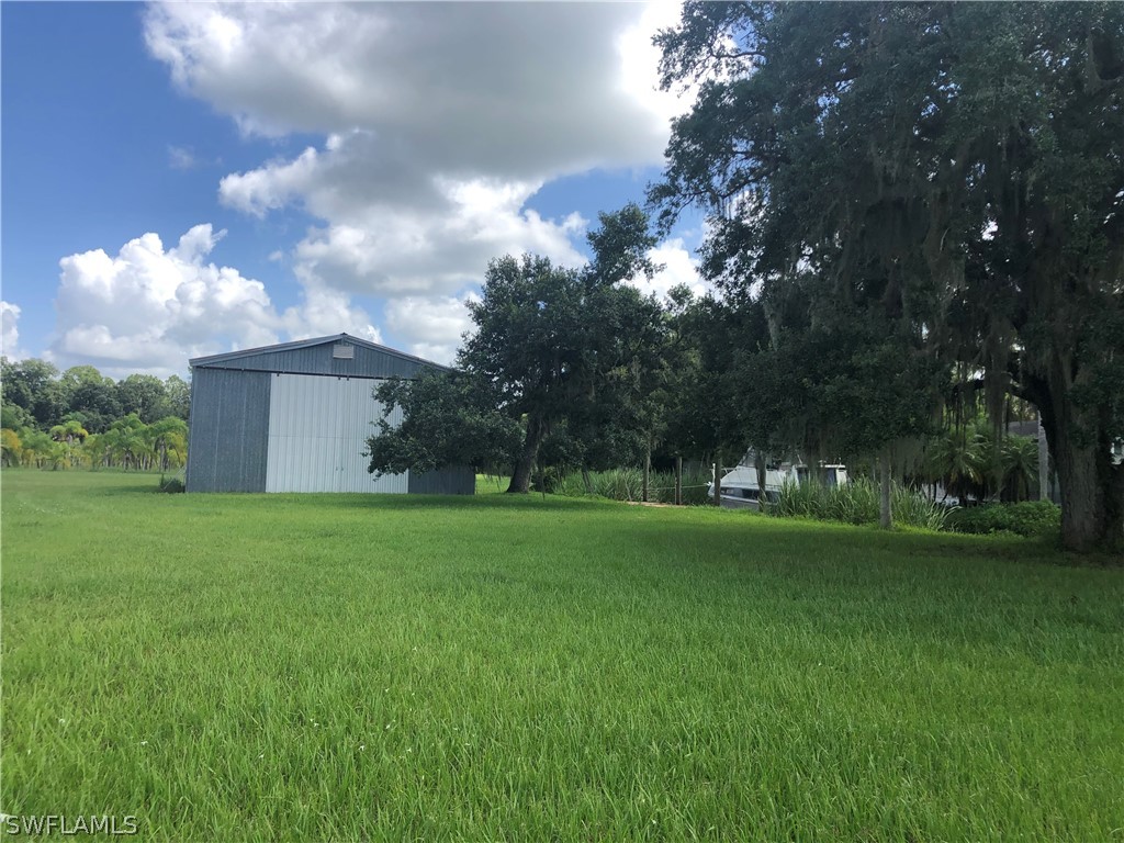 17800 Taylor Road Alva, FL 33920 - Photo 8 of 13 a view of a house with a big yard and garden