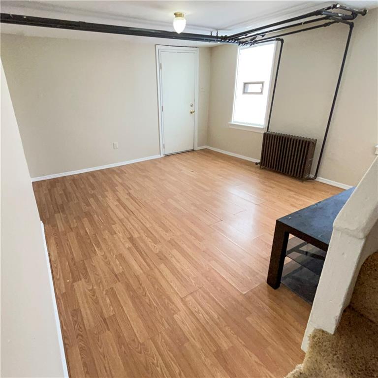 1360 Center Street McKees Rocks, PA 15136 - Photo 15 of 18 a view of an empty room with wooden floor and a window