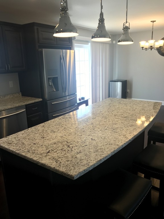 408 Smith Fall River Fall River, MA 02721 - Photo 3 of 19 a kitchen with kitchen island a sink dishwasher a stove and a refrigerator