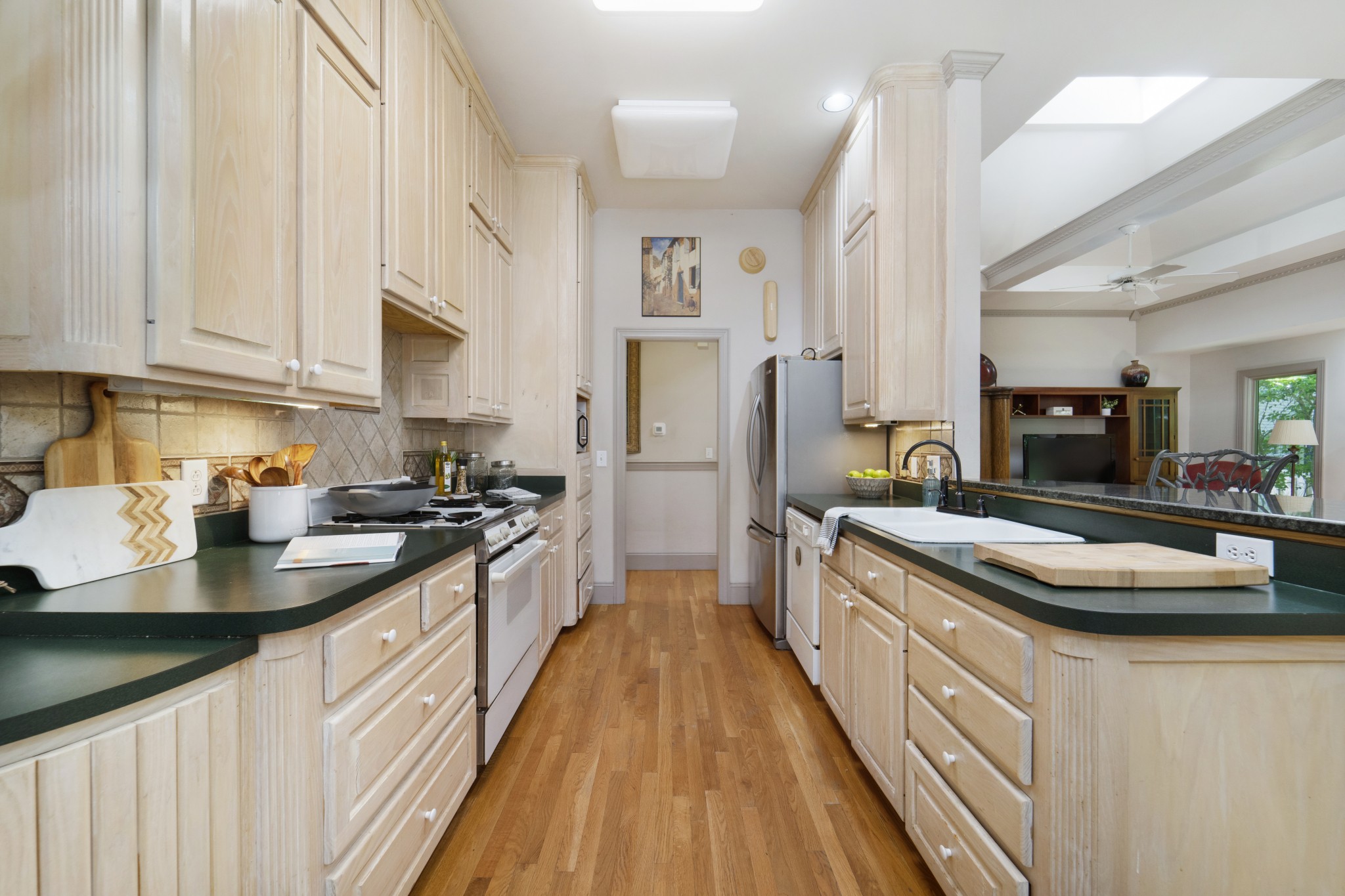 166 Hicks Road Nashville, TN 37221 - Photo 16 of 43 a large kitchen with stainless steel appliances granite countertop a lot of counter space and wooden floors
