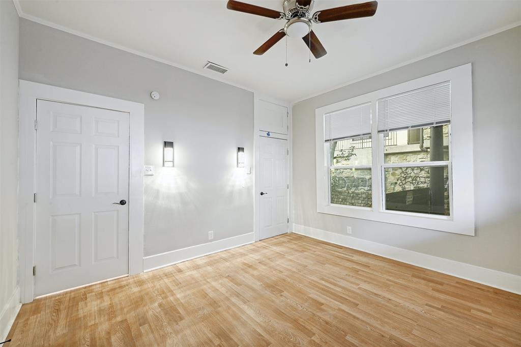 2511 San Gabriel Street Austin, TX 78705 - Photo 14 of 25 a view of a bedroom with wooden floor and windows