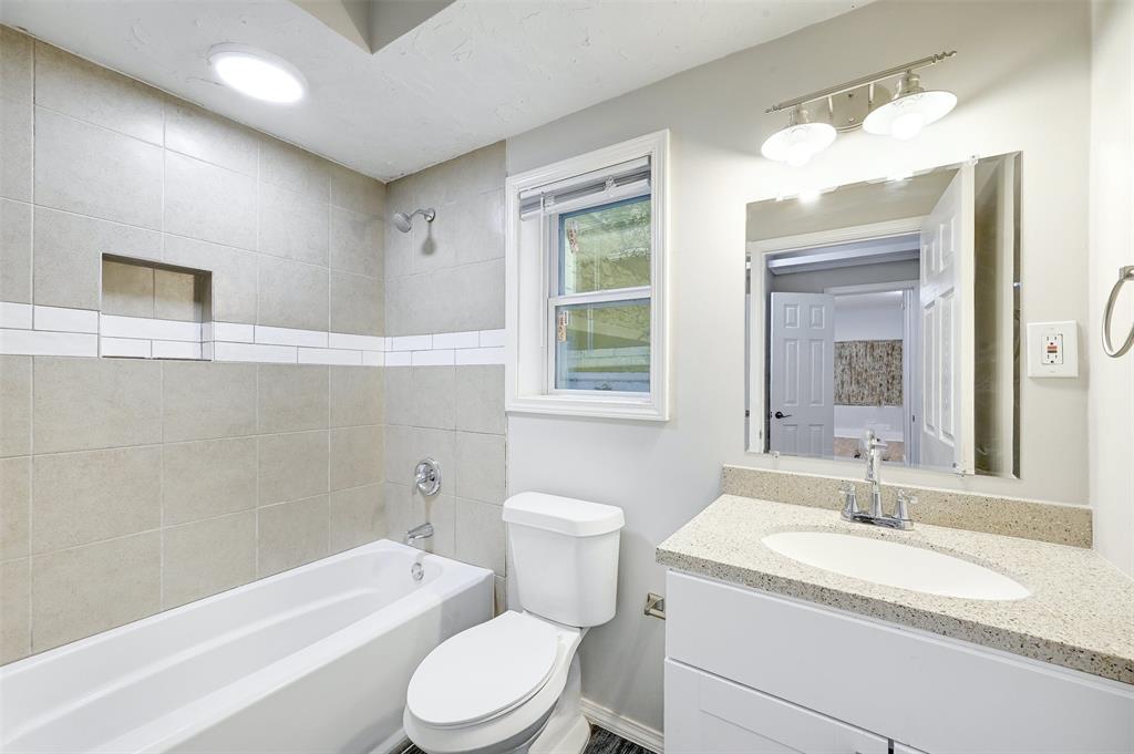 2511 San Gabriel Street Austin, TX 78705 - Photo 22 of 25 a bathroom with a granite countertop toilet a sink and a bathtub