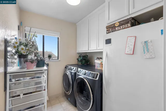 a utility room with sink dryer and washer