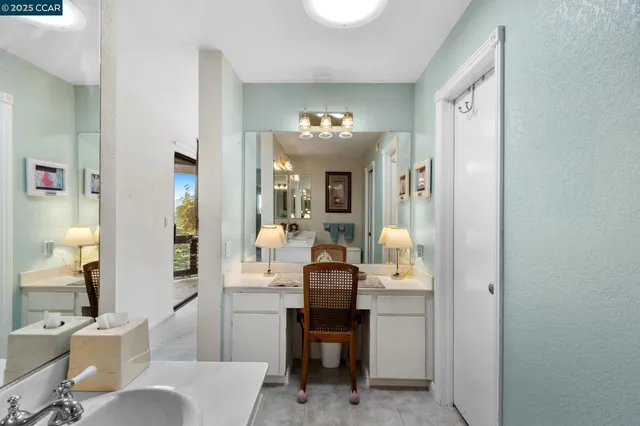 a view of a dining room with furniture and a chandelier