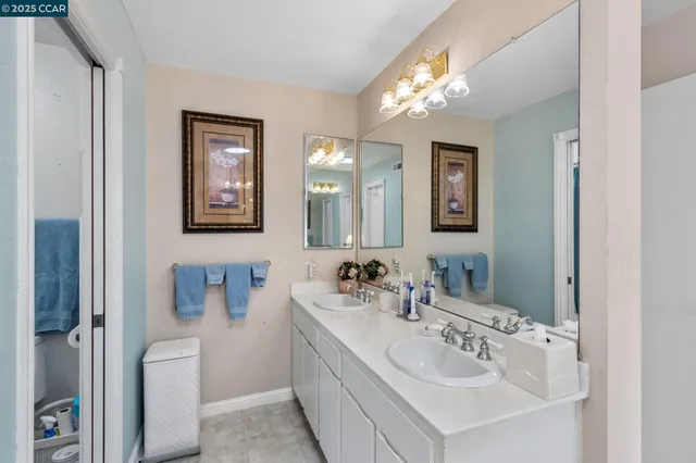 a bathroom with a sink a toilet and a mirror