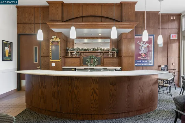 a view of a kitchen with kitchen island a stove a sink a refrigerator and yard