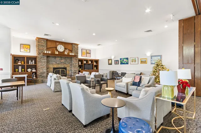 a living room with fireplace furniture and a wooden floor