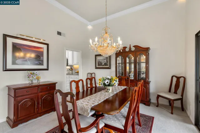 a dining room with furniture a livingroom and chandelier